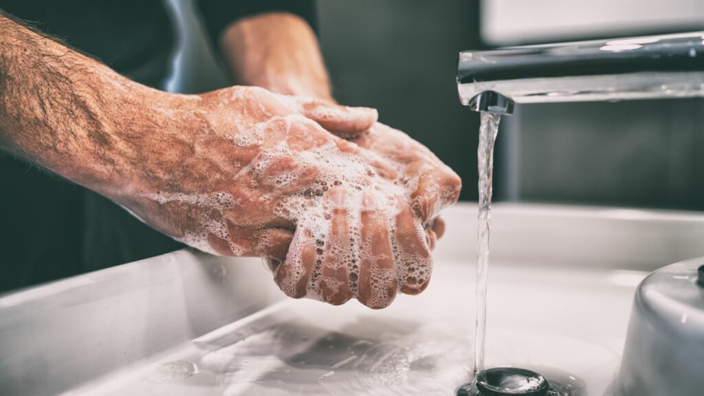 Elderly man washing hands